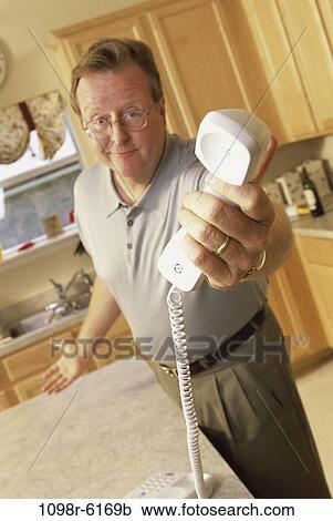 Stock Image - people, telephone, phone, holding, Middle-aged, hold. Fotosearch