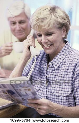 Picture - people, telephone, talking, couple, senior, magazine, phone. Fotosearch