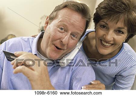 Stock Image - people, telephone, talking, couple, phone, Middle-aged, shopping. Fotosearch