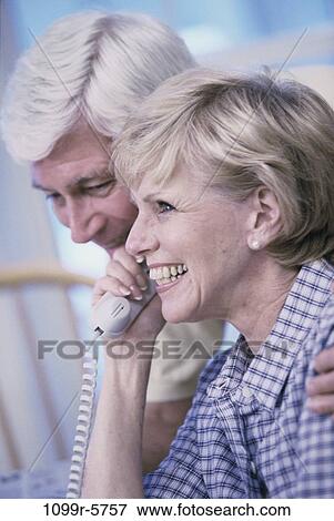 Stock Photo - people, telephone, talking, couple, senior, phone, indoors. Fotosearch