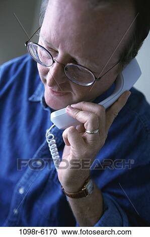 Stock Image - people, telephone, talking, eyeglasses, phone, Middle-aged. Fotosearch