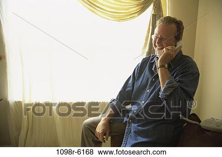 Stock Photo - people, telephone, talking, eyeglasses, phone, Middle-aged. Fotosearch