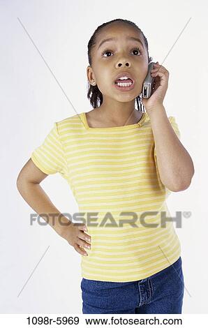 Stock Photo - people, telephone, talking, phone, girl, child, cell phone. Fotosearch