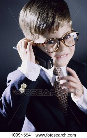 people, tie, suit, talking, eyeglasses, phone, boy View Large Photo Image Stock Image - people, tie, suit, talking, eyeglasses, phone, boy. Fotosearch