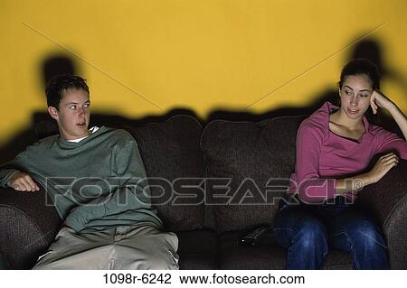 Stock Image - people, watch, couch, watching, television, apart, teens. Fotosearch