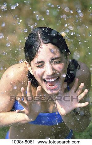 Stock Image - people, water, playing, rain, outdoors, droplets, play. Fotosearch