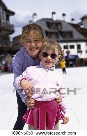 Stock Image - people, winter, sunglasses, outdoors, children, girls, ice skating. Fotosearch