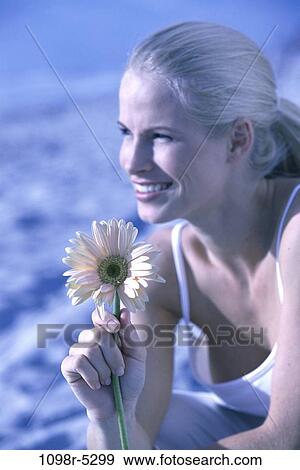 Stock Photo - people, woman, beach, flower, blond, romance, Caucasian. Fotosearch