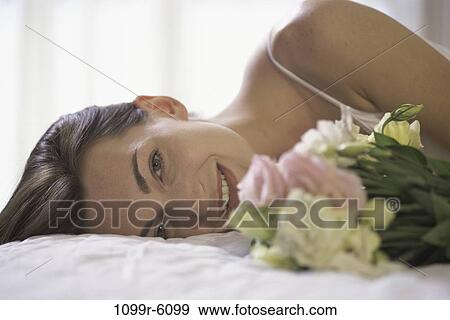 people, woman, bed, flowers, laying, brunette, indoors View Large Photo Image Stock Photo - people, woman, bed, flowers, laying, brunette, indoors. Fotosearch