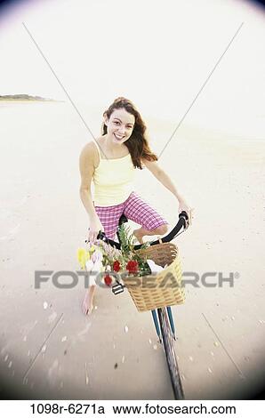Stock Image - people, woman, bicycle, outdoors, cycling, brunette. Fotosearch