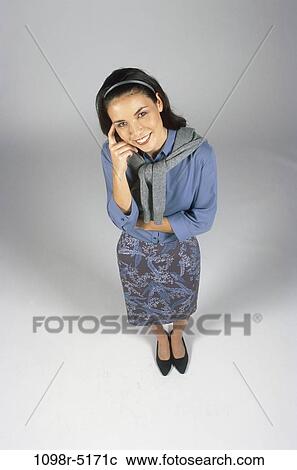 Stock Image - people, woman, brunette, indoors, Caucasian, conservative, young adult. Fotosearch