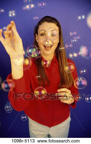 Stock Image - people, woman, bubbles, brunette, indoors, Caucasian, young adult. Fotosearch