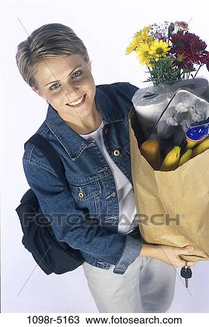 Stock Image - people, woman, carrying, shopping, blond, grocery, food. Fotosearch