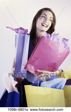 Stock Image - people, woman, carrying, shopping, shop, bags, shopping bags. Fotosearch