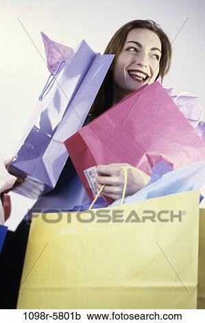 Stock Image - people, woman, carrying, shopping, shop, bags, shopping bags. Fotosearch