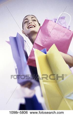 Stock Photograph - people, woman, carrying, shopping, shop, bags, shopping bags. Fotosearch
