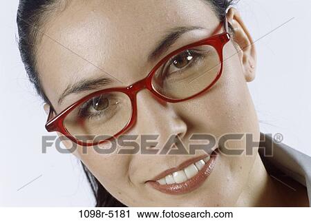 Stock Image - people, woman, eyeglasses, Hispanic, brunette, indoors, headshot. Fotosearch