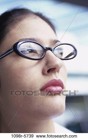 Stock Photo - people, woman, eyeglasses, Hispanic, business, serious, contemplating. Fotosearch