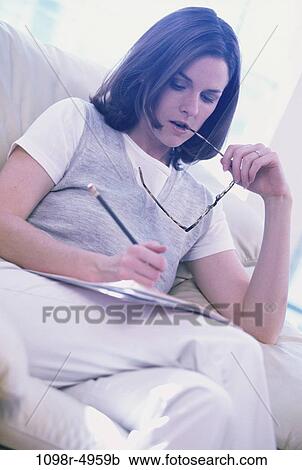 Stock Image - people, woman, eyeglasses, contemplating, brunette, indoors, contemplate. Fotosearch