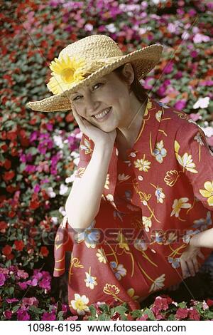 Stock Photography - people, woman, flowers, outdoors, garden, Middle-aged, straw hat. Fotosearch