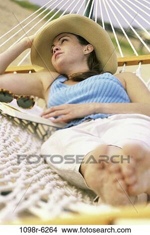 people, woman, hat, daydreaming, hammock, sunglasses, outdoors View Large Photo Image Picture - people, woman, hat, daydreaming, hammock, sunglasses, outdoors. Fotosearch