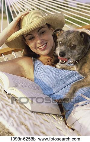people, woman, hat, dog, pet, hammock, book View Large Photo Image Stock Image - people, woman, hat, dog, pet, hammock, book. Fotosearch