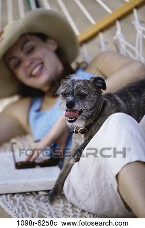 people, woman, hat, dog, pet, hammock, book View Large Photo Image Stock Image - people, woman, hat, dog, pet, hammock, book. Fotosearch