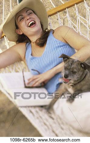 people, woman, hat, dog, pet, laughing, hammock View Large Photo Image Stock Image - people, woman, hat, dog, pet, laughing, hammock. Fotosearch
