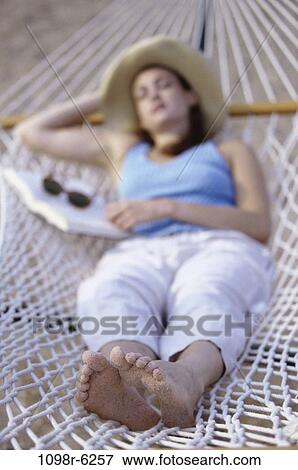 people, woman, hat, sleeping, hammock, sunglasses, outdoors View Large Photo Image Stock Photo - people, woman, hat, sleeping, hammock, sunglasses, outdoors. Fotosearch