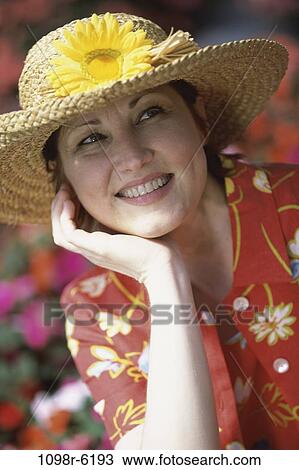 Stock Image - people, woman, hat, upward, outdoors, Middle-aged, straw hat. Fotosearch