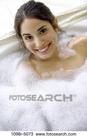 Stock Image - people, woman, Hispanic, bubble, bath, brunette, indoors. Fotosearch