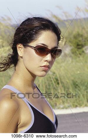 people, woman, Hispanic, sunglasses, outdoors, serious, brunette View Large Photo Image Stock Image - people, woman, Hispanic, sunglasses, outdoors, serious, brunette. Fotosearch