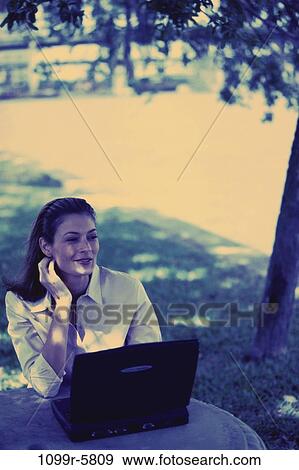 people, woman, laptop, outdoors, Middle-aged, brunette, Caucasian View Large Photo Image Stock Photo - people, woman, laptop, outdoors, Middle-aged, brunette, Caucasian. Fotosearch