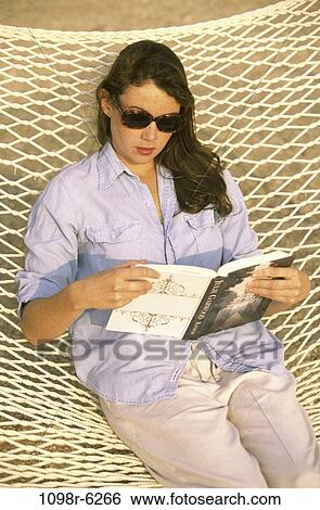 people, woman, reading, hammock, book, sunglasses, outdoors View Large Photo Image Stock Photograph - people, woman, reading, hammock, book, sunglasses, outdoors. Fotosearch