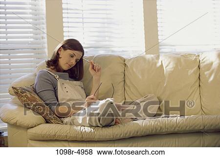 people, woman, reading, leather, sofa, brunette, indoors View Large Photo Image Stock Photo - people, woman, reading, leather, sofa, brunette, indoors. Fotosearch