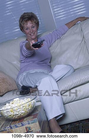 people, woman, senior, popcorn, watch, watching, television View Large Photo Image Stock Image - people, woman, senior, popcorn, watch, watching, television. Fotosearch