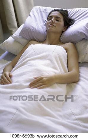 Stock Image - people, woman, sleeping, bed, relaxing, resting, brunette. Fotosearch