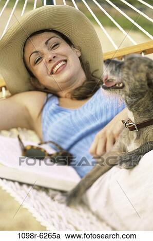 people, woman, smiling, hat, dog, pet, hammock View Large Photo Image Stock Image - people, woman, smiling, hat, dog, pet, hammock. Fotosearch