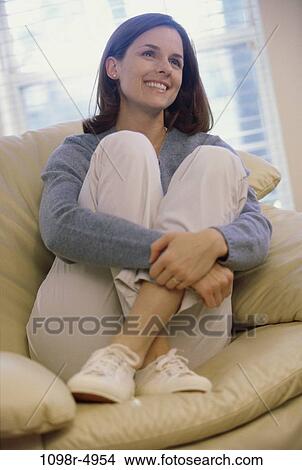 people, woman, sofa, brunette, indoors, Caucasian, young adult View Large Photo Image Picture - people, woman, sofa, brunette, indoors, Caucasian, young adult. Fotosearch