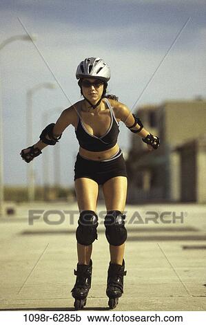 Stock Image - people, woman, sunglasses, outdoors, skating, safety, Caucasian. Fotosearch