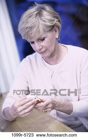 people, woman, table, senior, bottle, reading, prescription View Large Photo Image Stock Image - people, woman, table, senior, bottle, reading, prescription. Fotosearch