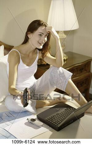 people, woman, telephone, computer, laptop, phone, bed View Large Photo Image Picture - people, woman, telephone, computer, laptop, phone, bed. Fotosearch
