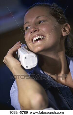 Stock Photo - people, woman, telephone, talking, phone, cordless, indoors. Fotosearch