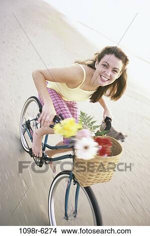Picture - people, woman, walking, dog, bicycle, pet, beach. Fotosearch