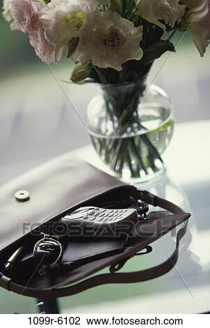 phone, sunglasses, flowers, purse, vase, still life, handbag View Large Photo Image Stock Image - phone, sunglasses, flowers, purse, vase, still life, handbag. Fotosearch