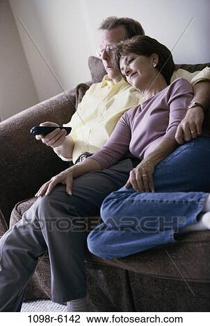 relaxed, people, couple, sitting, watch, couch, sofa View Large Photo Image Stock Image - relaxed, people, couple, sitting, watch, couch, sofa. Fotosearch