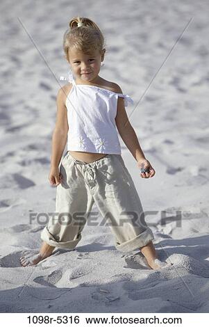 rock, sand, people, beach, holding, girl, standing View Large Photo Image Stock Photograph - rock, sand, people, beach, holding, girl, standing. Fotosearch