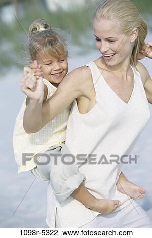 sand, people, mother, beach, outdoors, carrying, family View Large Photo Image Stock Image - sand, people, mother, beach, outdoors, carrying, family. Fotosearch