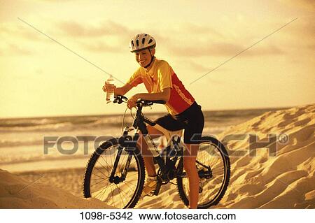 Stock Image - sand, people, water, woman, dunes, drinking, beach. Fotosearch