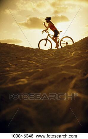 Stock Photograph - sand, people, woman, dunes, drinking, sunset, beach. Fotosearch